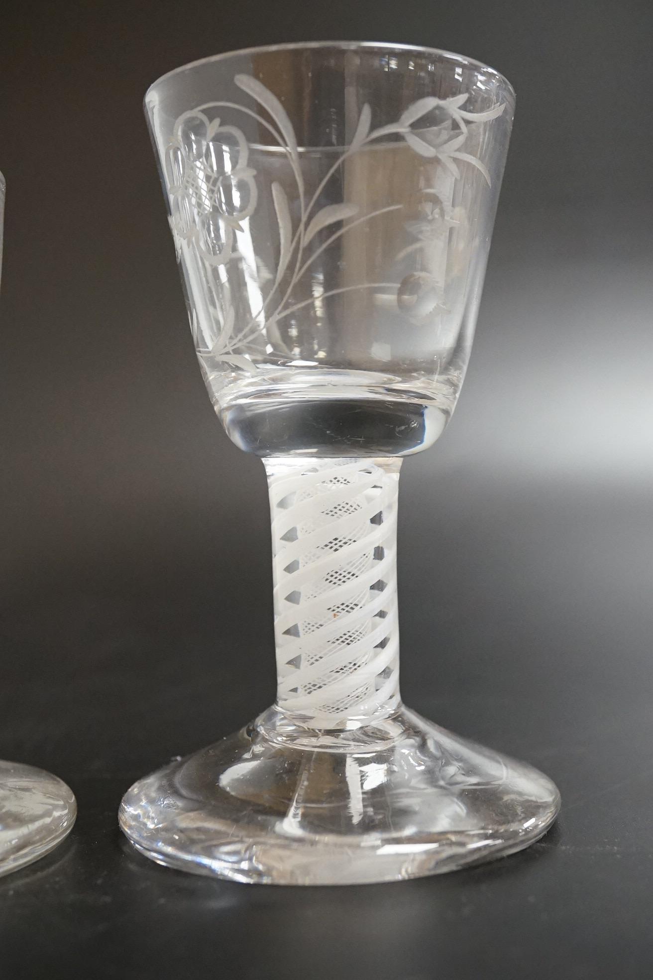 Two George III firing glasses, one with DSOT stem, together with a gin glass with engraved bowl, tallest 11.5cm high (3)